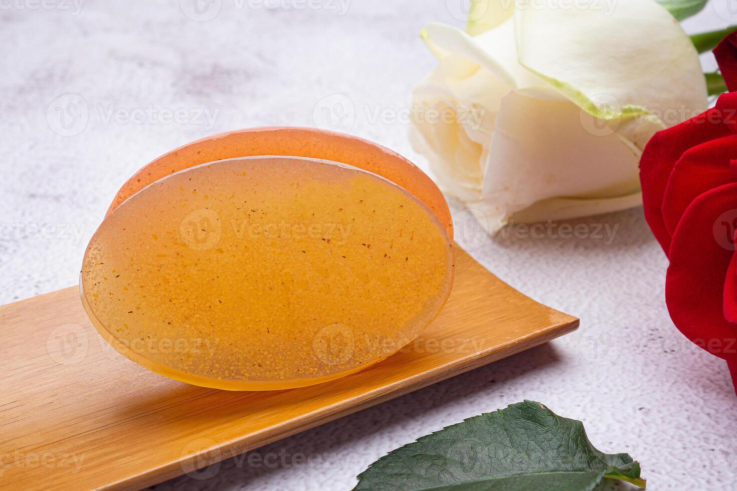 Organic soaps homemade with ingredients are honey placed on a bamboo plate with a gray stone background. Soap protection or prevent acne, bacteria in both body, and facial. Concept of healthcare photo