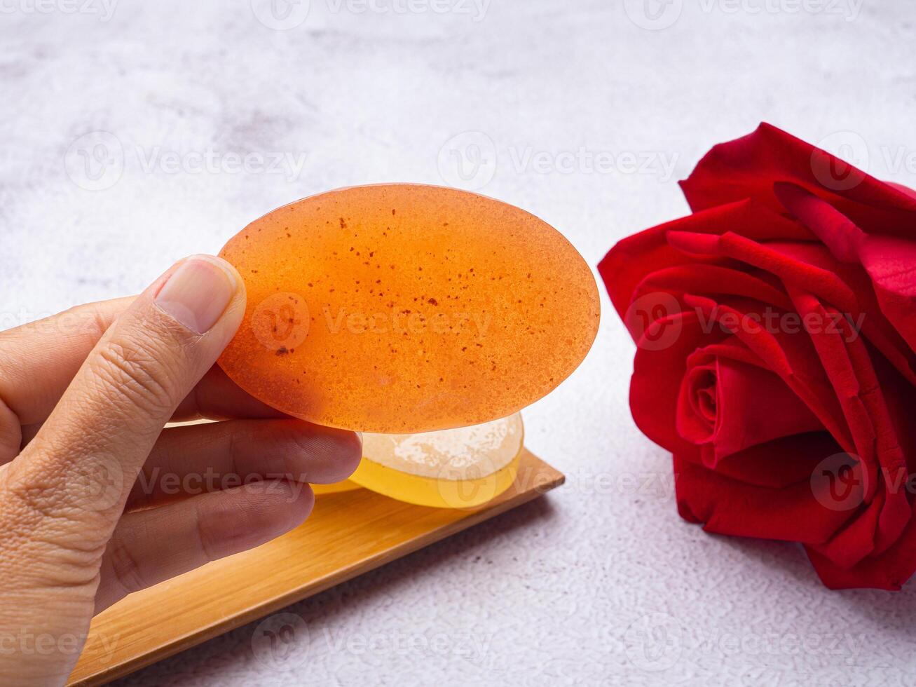Hand holding of an organic soap homemade with ingredients is honey. Soap protection or prevent acne, bacteria in both body, and facial. Close-up photo. Concept of healthcare photo