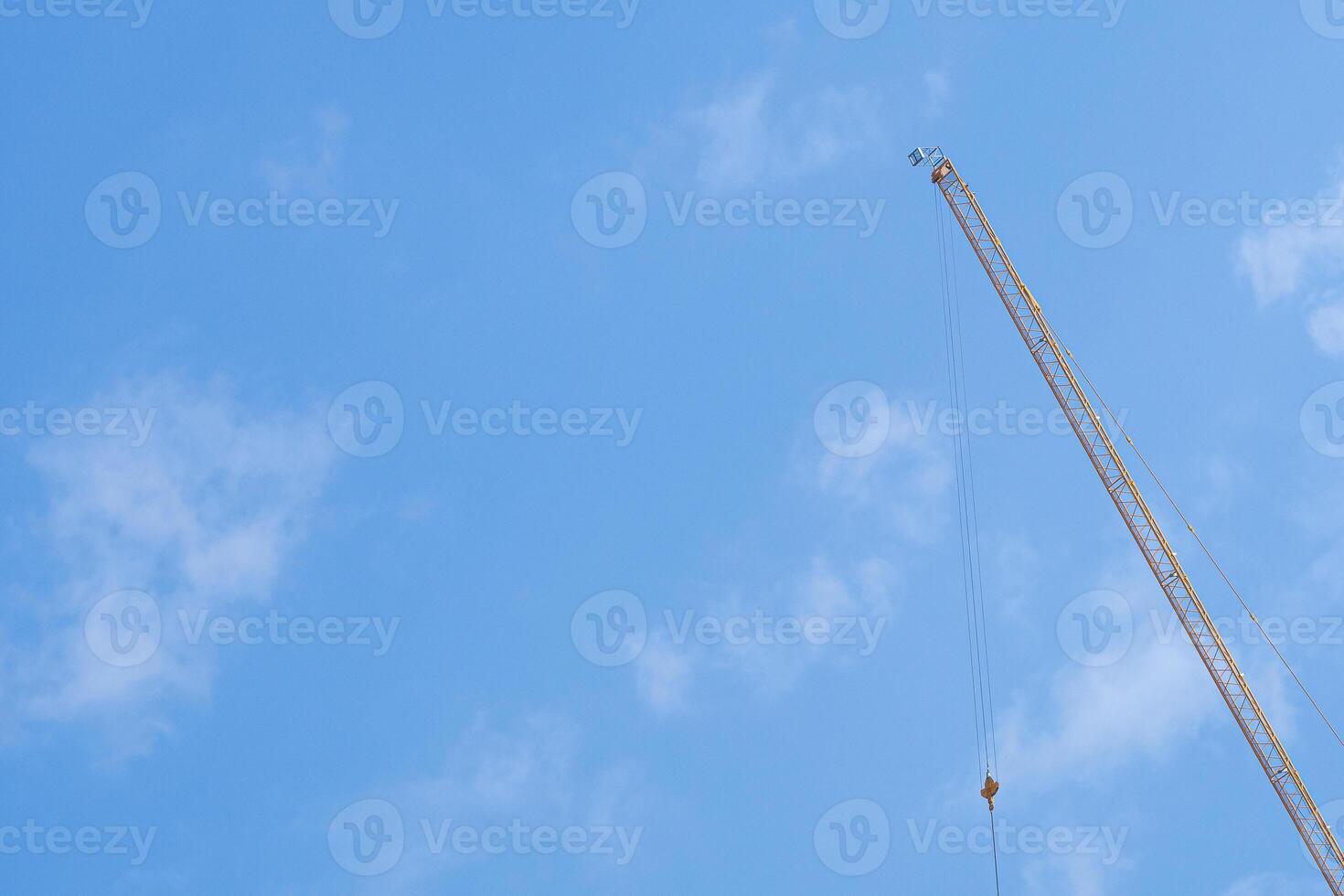 Construction site with the crane on sky background. Big yellow machinery construction crane tool of building industry for heavy lifting. Business engineering equipment modern photo