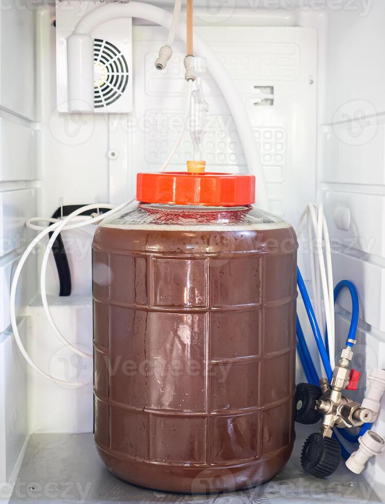 Close-up of craft beer and foam in a fermentation container. photo