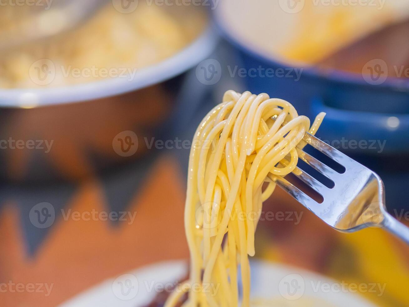 Spaghetti on a silver fork. Space for text photo