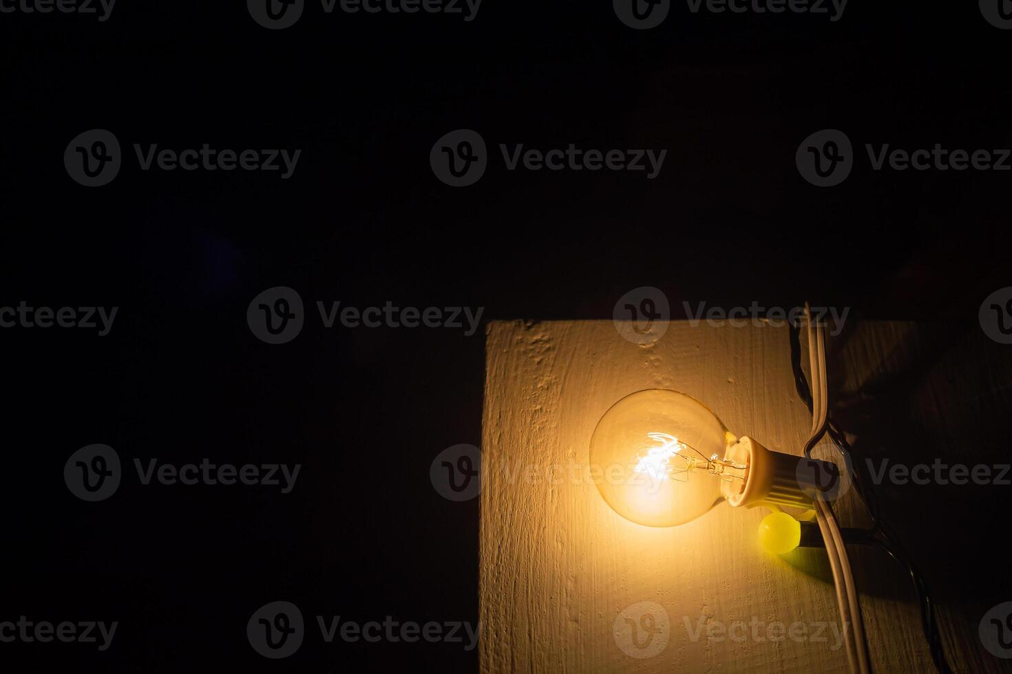 Light bulbs placed on a wooden chair a part of outdoor party decor photo