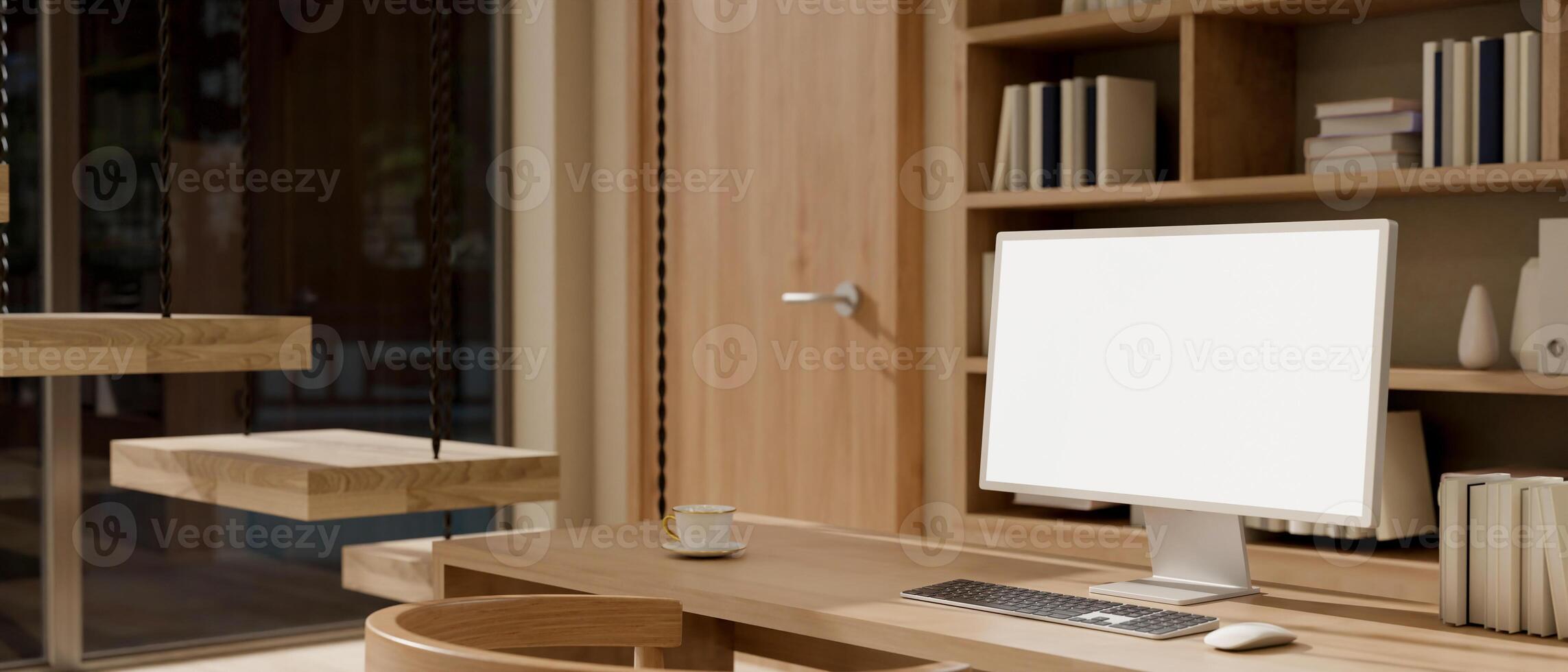 A computer with a white-screen mockup with decor are on a wooden desk in a minimalist home office. photo