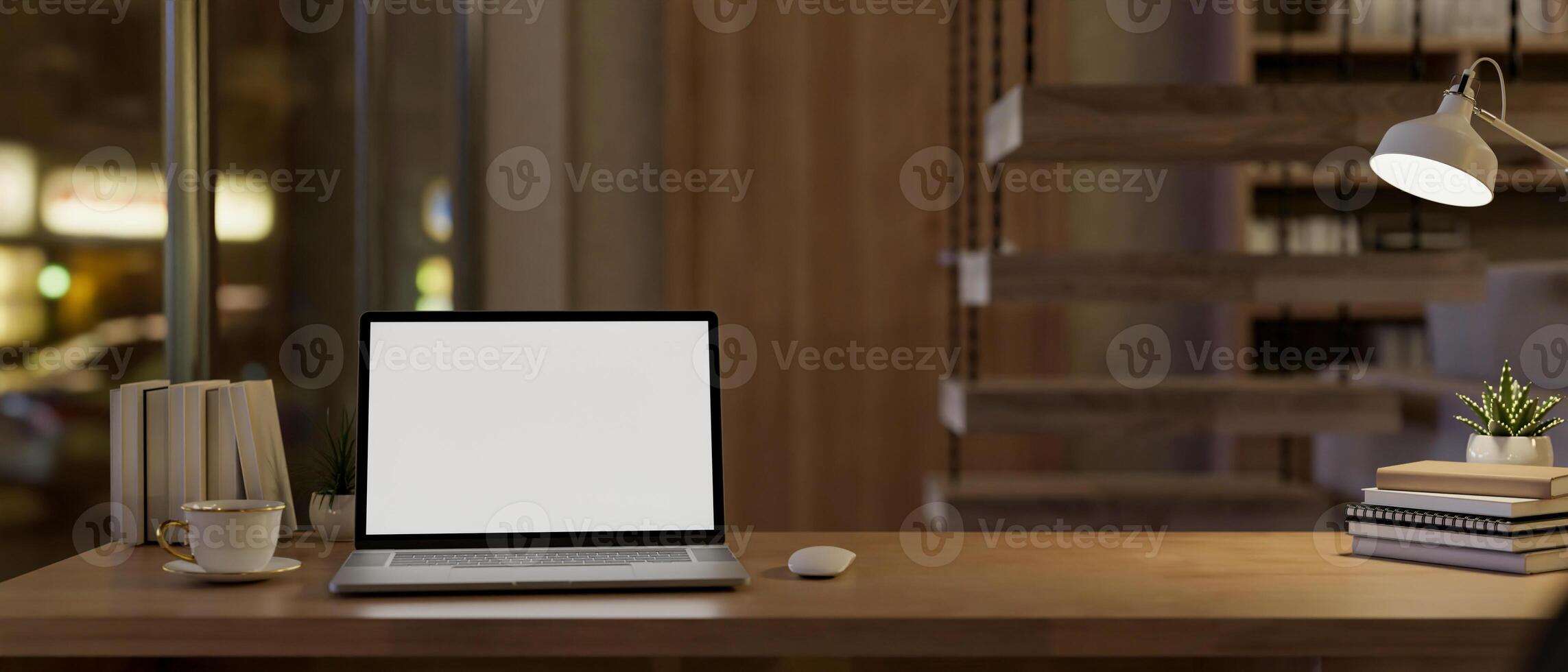A laptop computer with a white-screen mockup on a wooden table in a modern home at night. photo