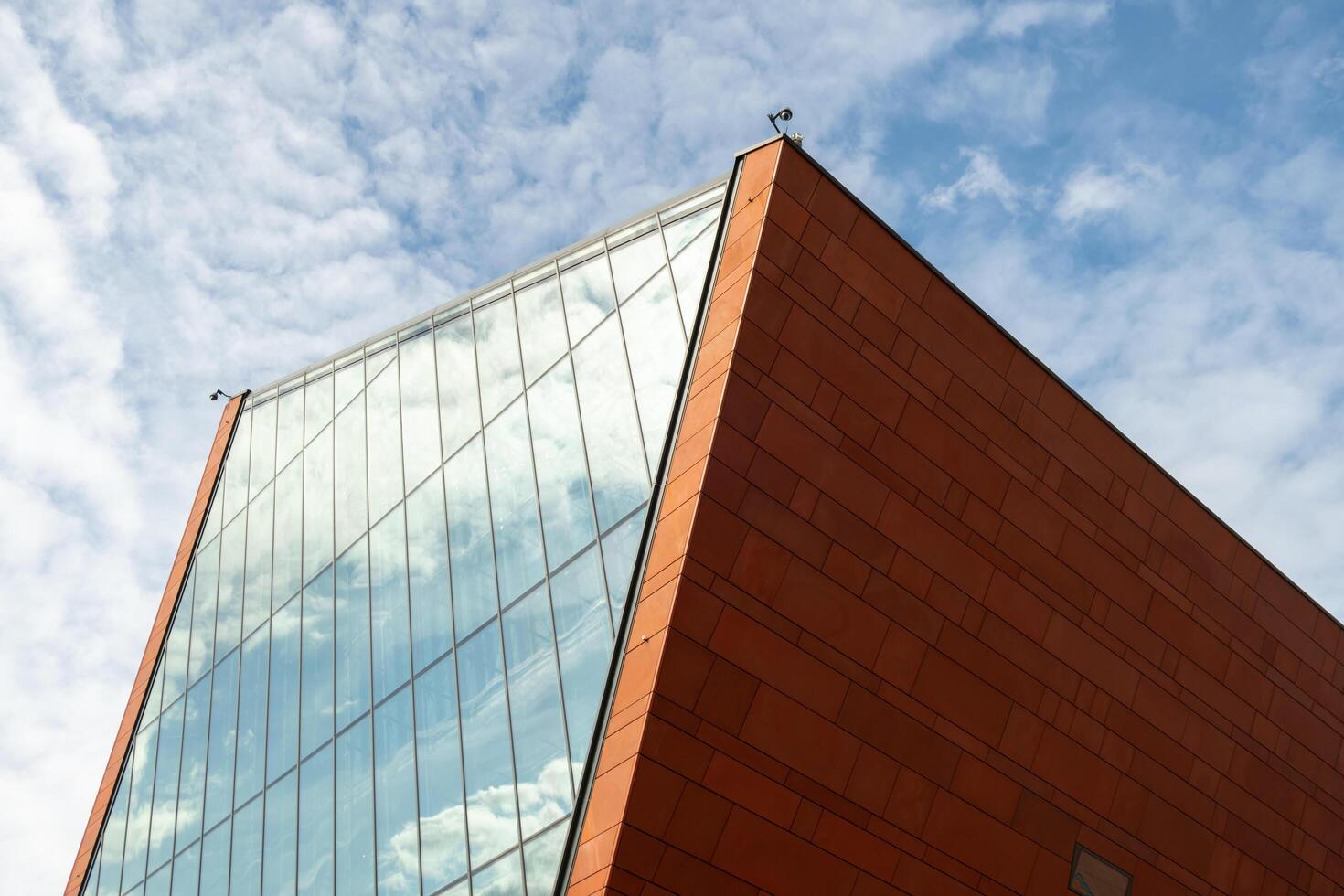 Gdansk Poland May 2022. Museum of the Second World War Modern exterior with glass facade. Transparent glass wall of museum. Element of facade of modern European building. Abstract modern architecture photo