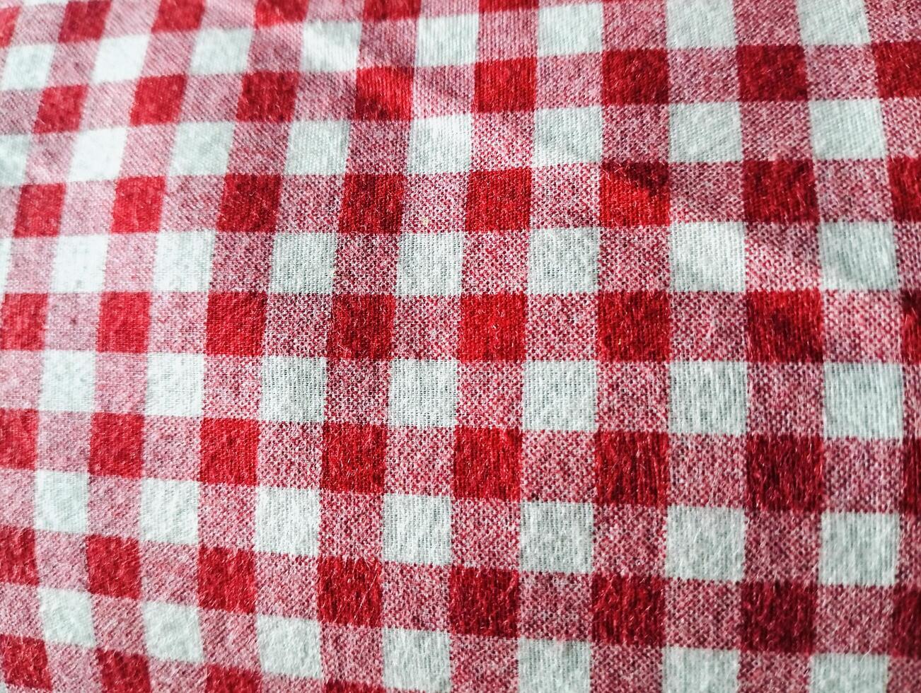 Red and white checkered tablecloth. Top view table cloth texture background. Red gingham pattern fabric. Picnic blanket texture. Red table cloth for Italian food menu. Square pattern. photo