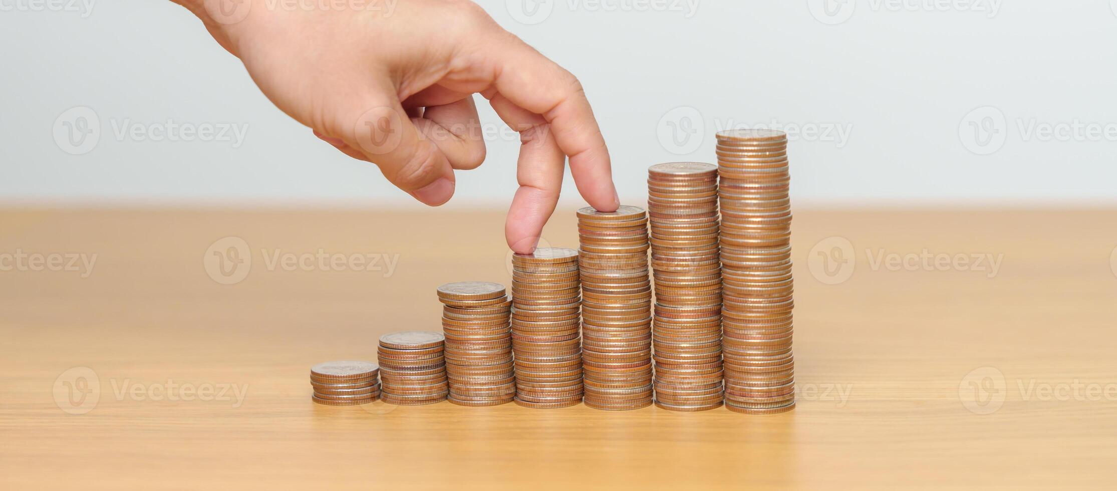 Money Saving for Future Plan, Retirement fund, Pension, Investment, Wealth, Salary and Financial concepts. hand step up coin on table, Money Counting and stack arrangement for Growth photo