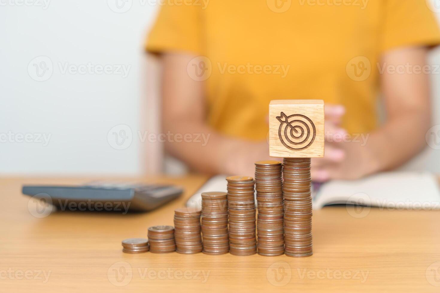 Money Saving for Future Plan, Retirement fund, budget, Goal and strategy Investment, Wealth Business and Financial concepts. Woman with Coins stack and dartboard block on table photo