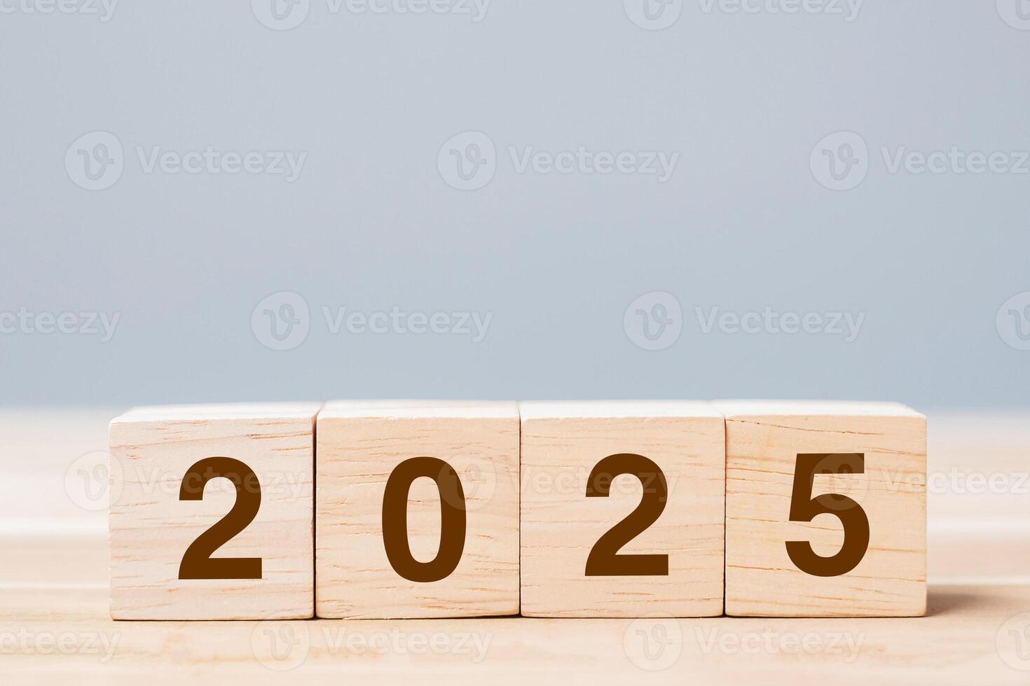 wooden cube block with 2025 text on table background. Resolution, plan, review, goal, start and New Year holiday concepts photo