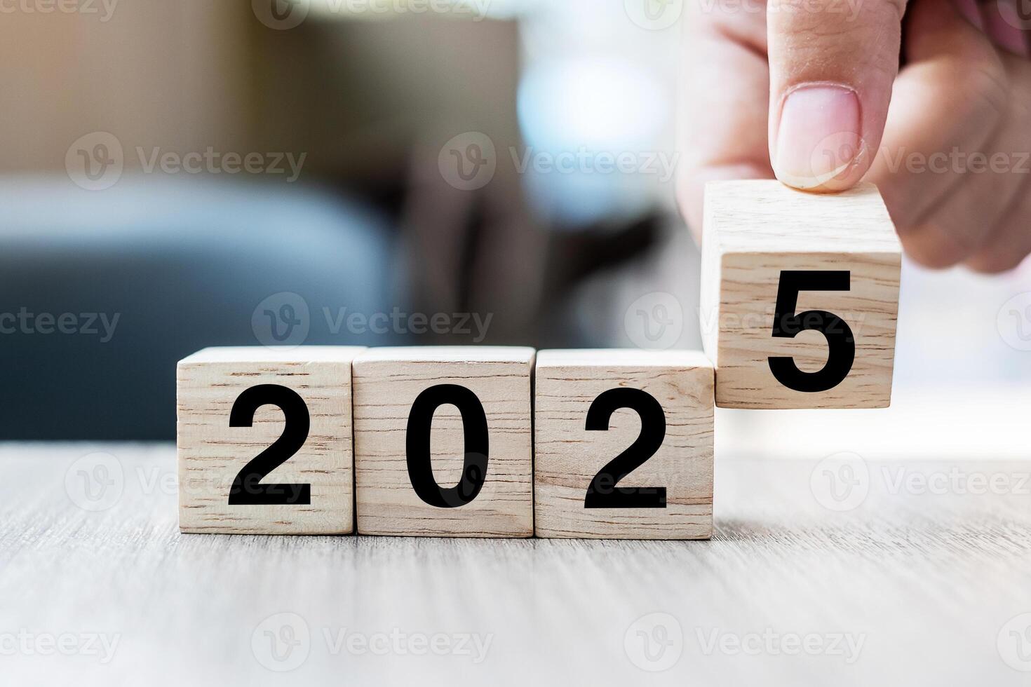 hand flipping block 2024 to 2025 text on table. Resolution, strategy, plan, goal, motivation, reboot, business and New Year holiday concepts photo