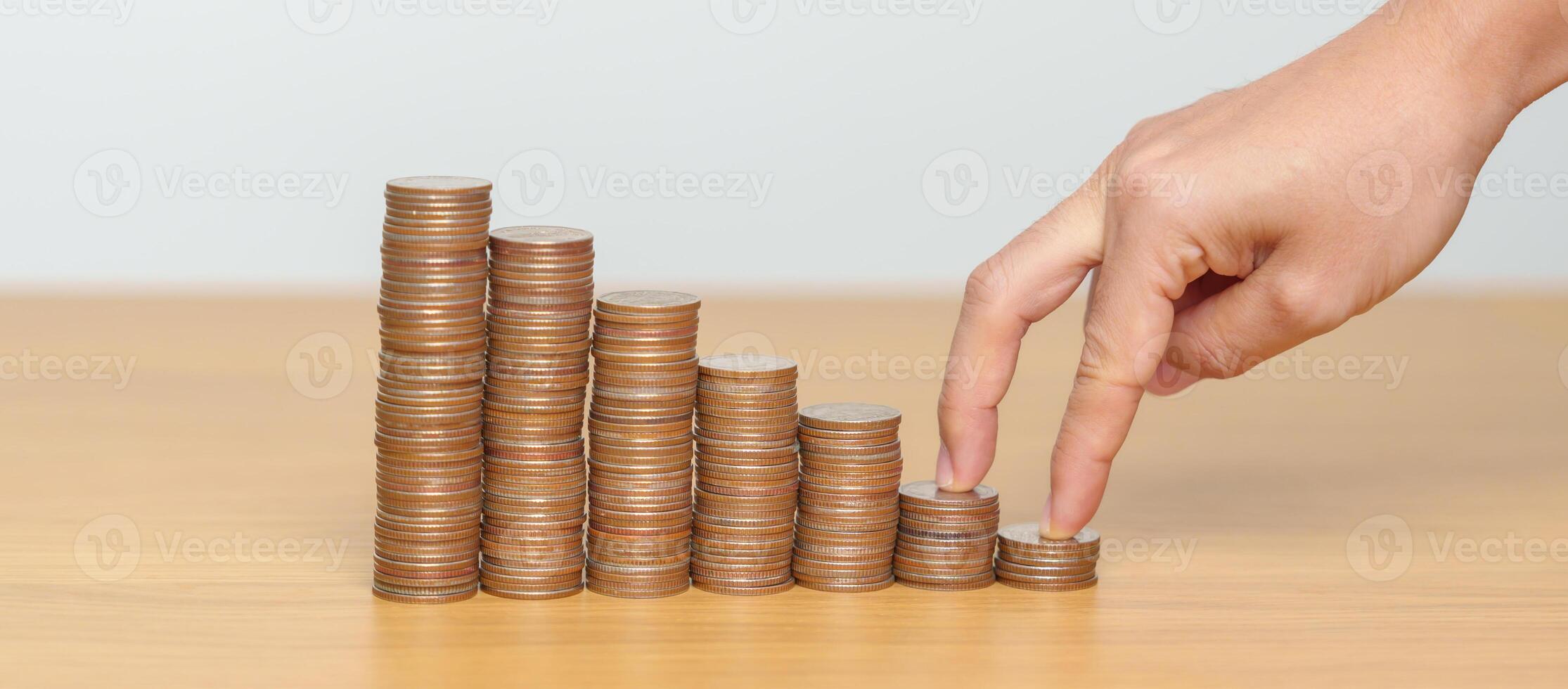 Money Saving for Future Plan, Retirement fund, Pension, Investment, Wealth, Salary and Financial concepts. hand step up coin on table, Money Counting and stack arrangement for Growth photo