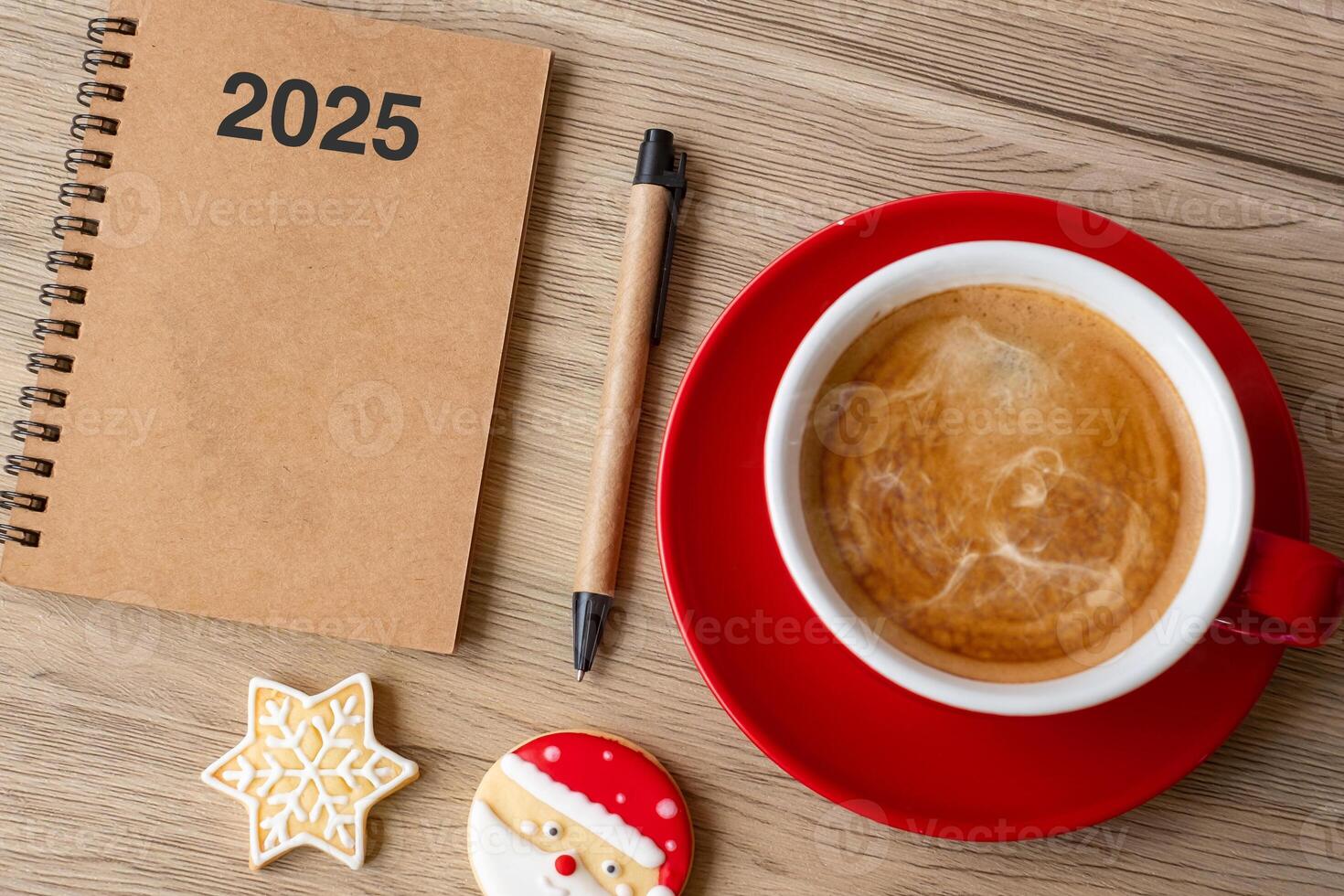 2025 GOAL with notebook, coffee cup, Christmas cookies and pen on wood table. Xmas, Happy New Year, Resolution, To do list, Strategy and Plan concept photo