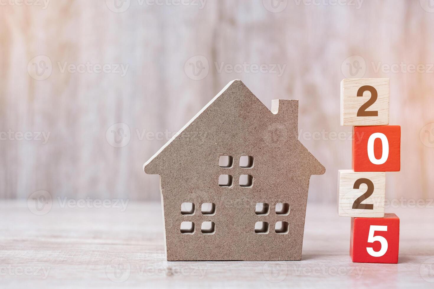 2025 Happy New Year with house model on table wooden background. Banking, real estate, investment, financial, savings and New Year Resolution concepts photo