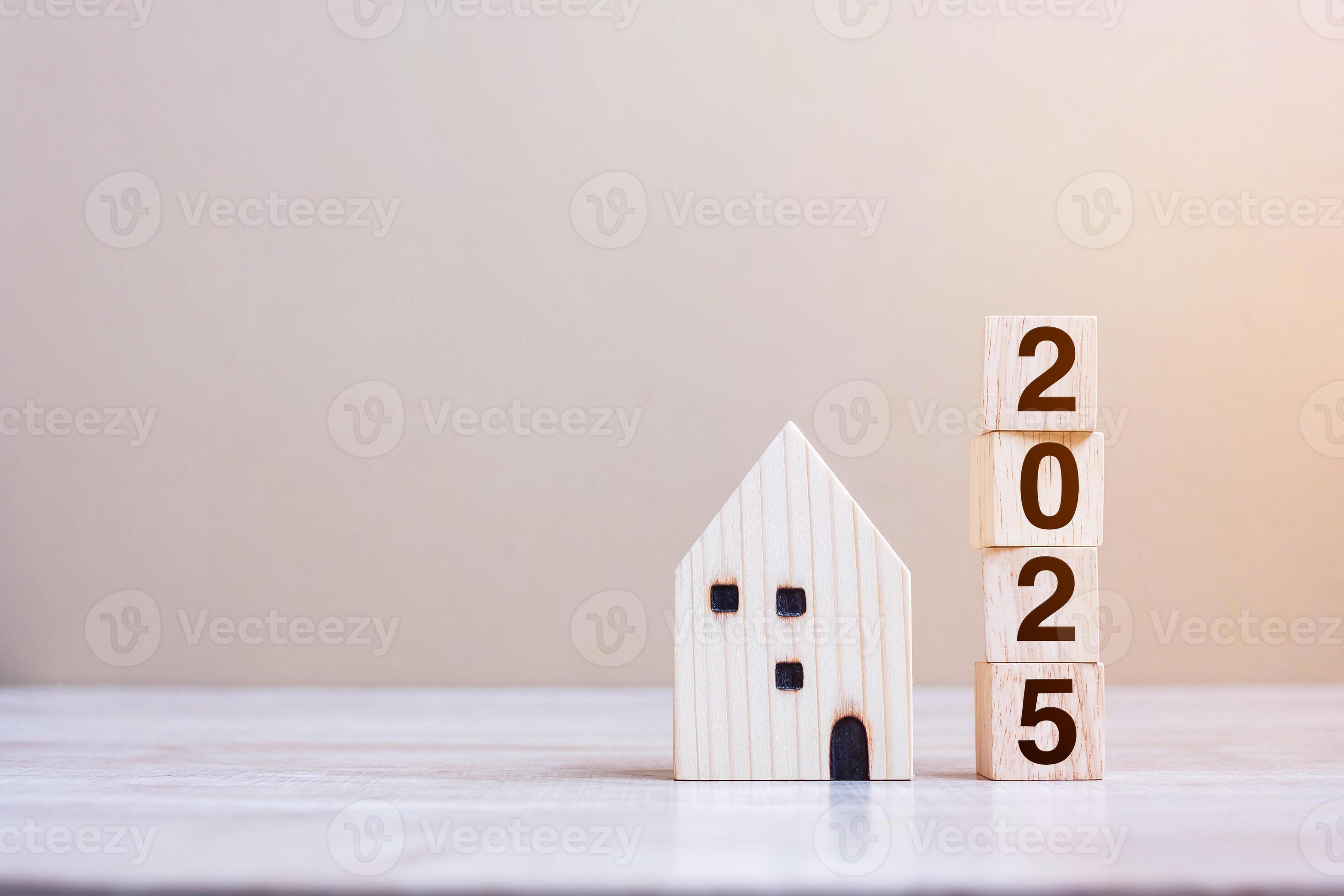 2025 Happy New Year with house model on table wooden background