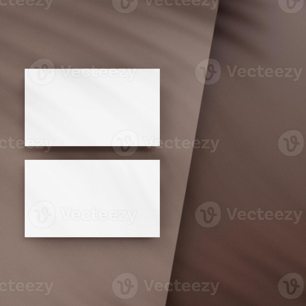 Blank business cards on brown background photo