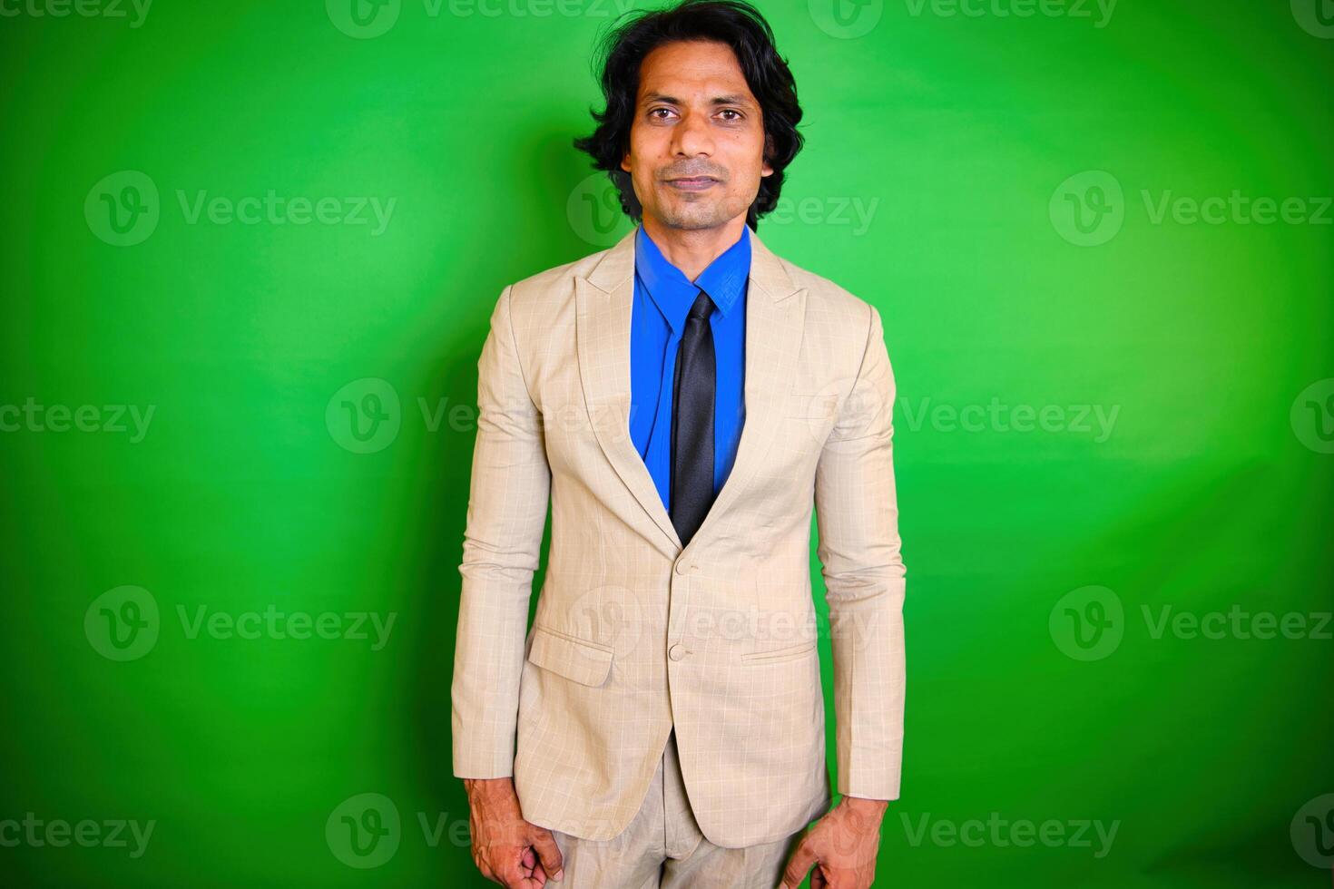 Smiling man in beige suit posing photo