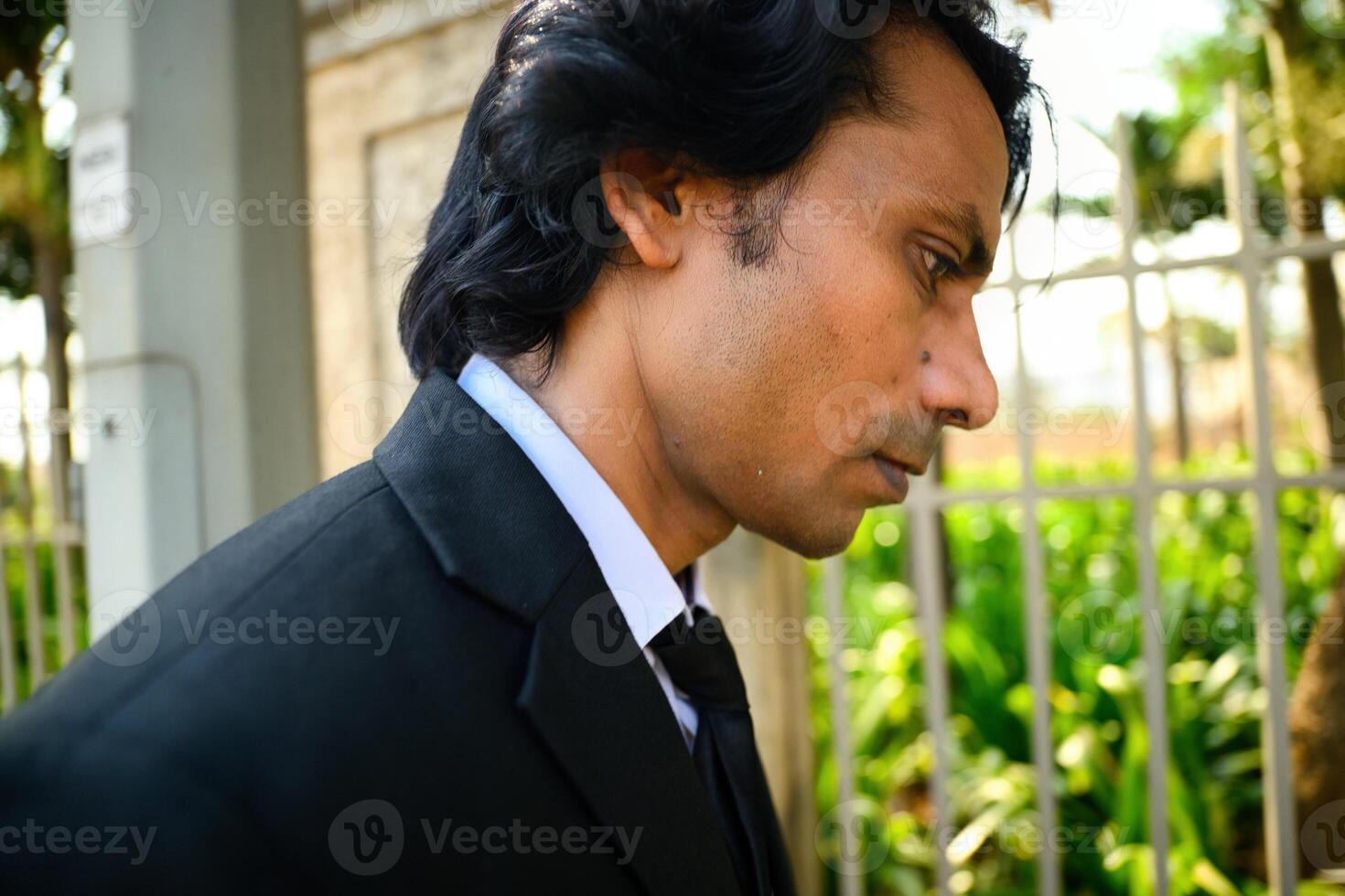 Thoughtful businessman standing on street photo