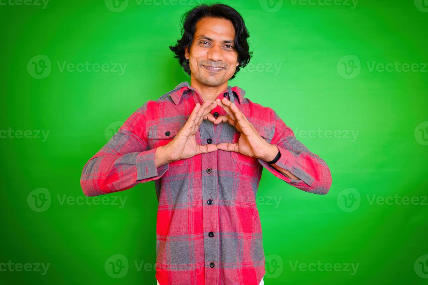 Man making heart shape with hands photo