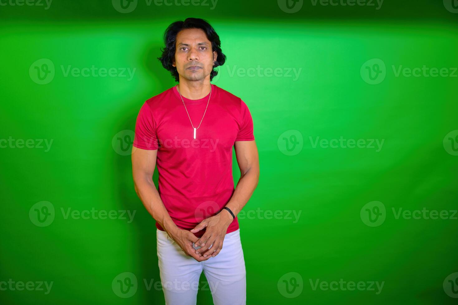 Serious young man standing looking at camera photo