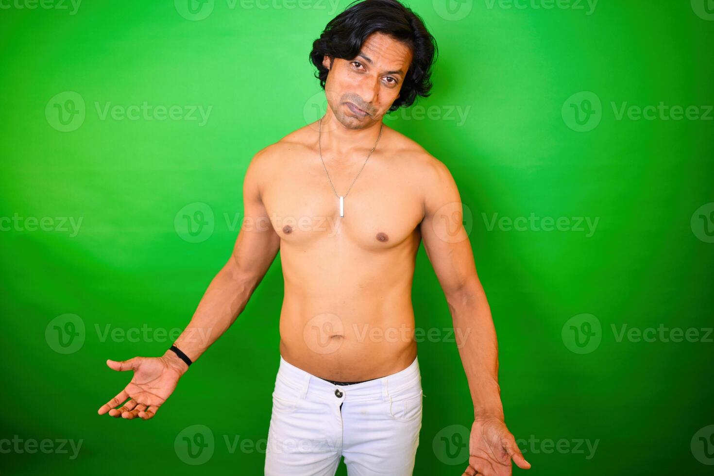 Shirtless man with expressive look posing photo