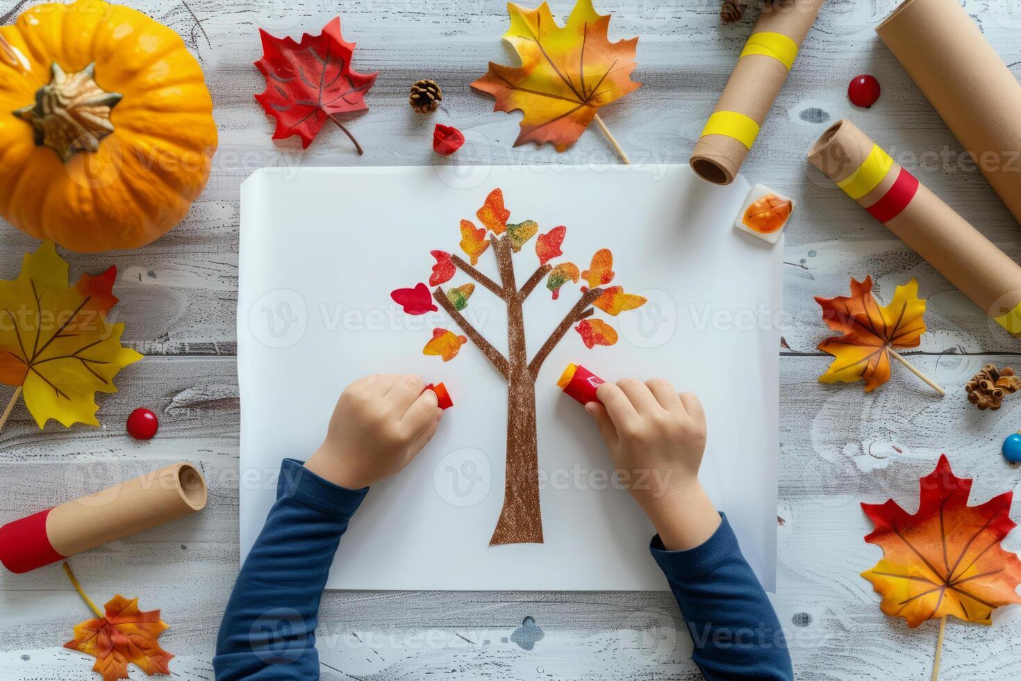 Child making school project, autumn tree made of paper photo
