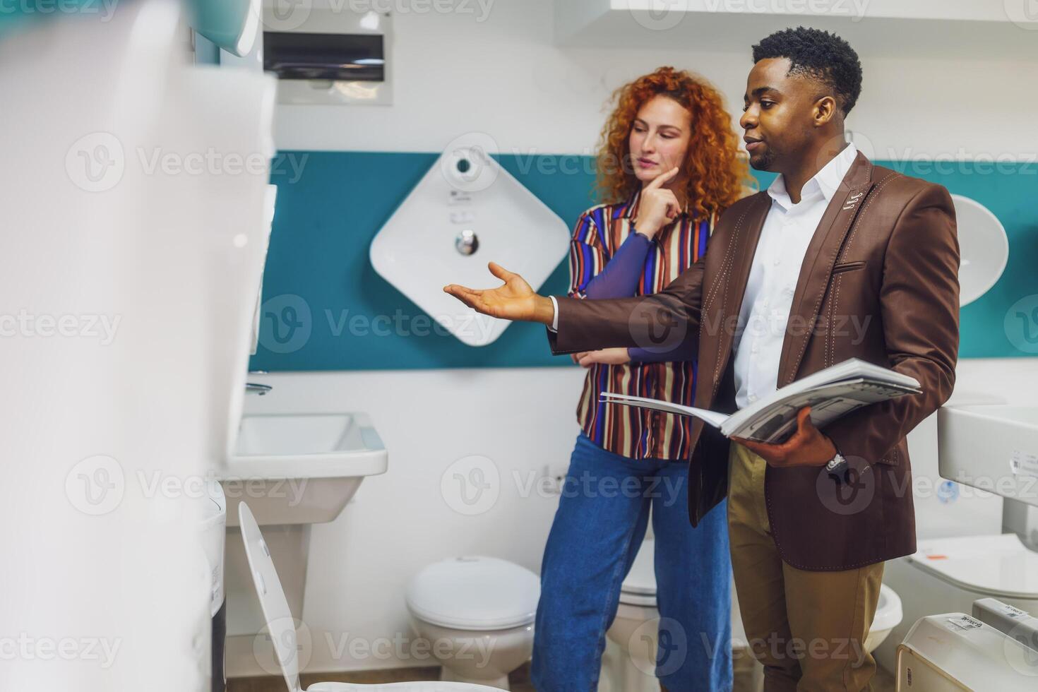 Salesman is talking with a customer who is choosing the goods. photo