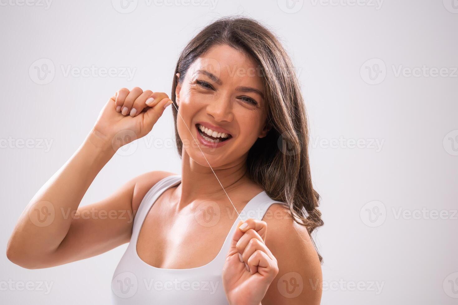Portrait of adult woman who is brushing her teeth. photo