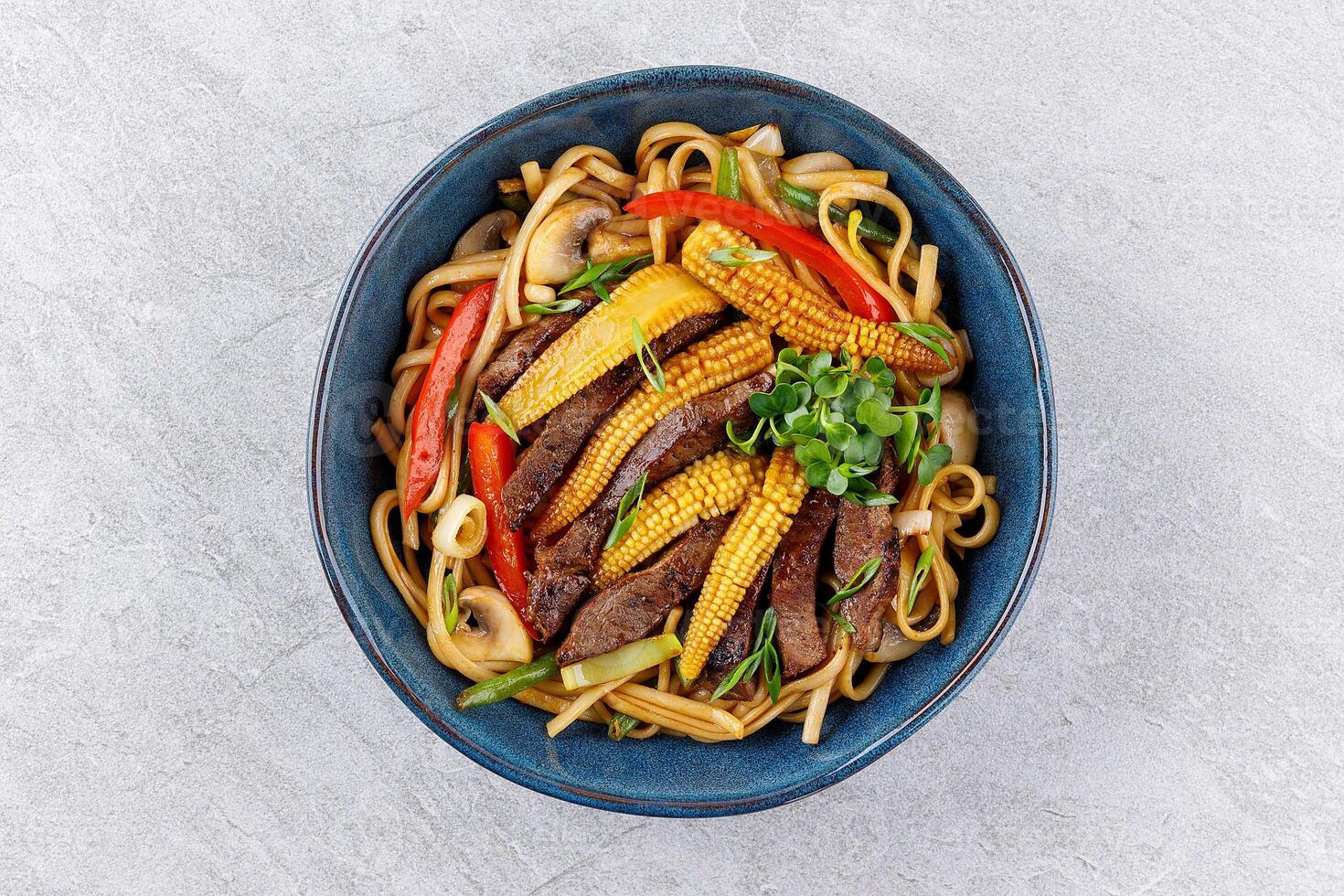 Udon noodles with beef and vegetables for the menu, website, restaurant or food delivery photo