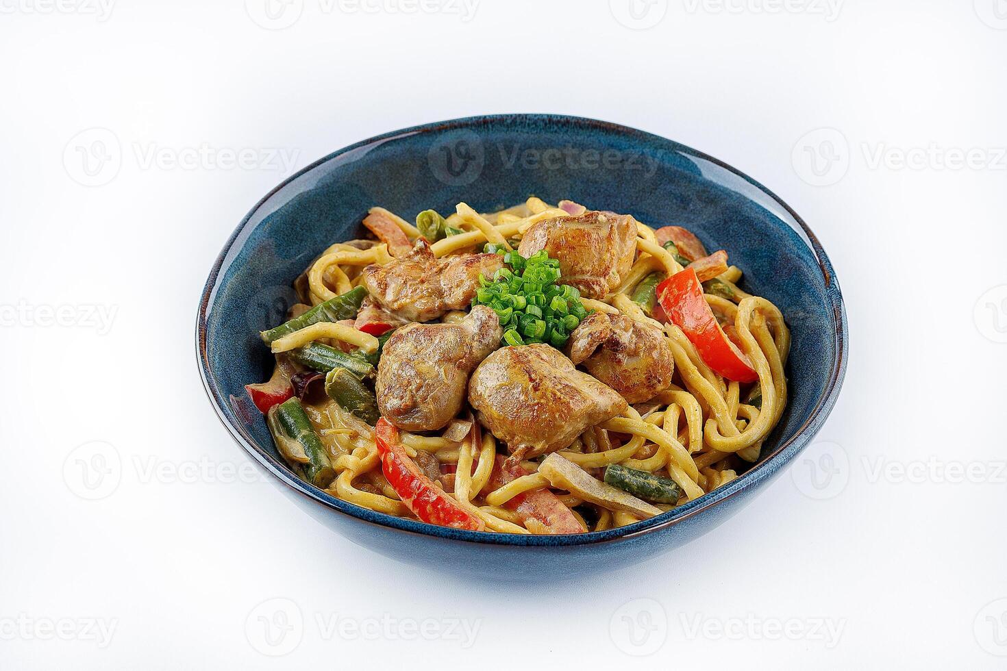 Egg noodles with curry sauce and chicken on a white background photo
