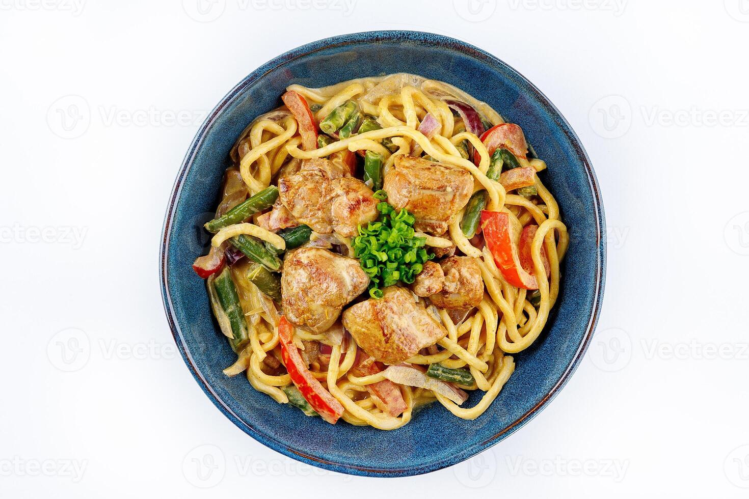 Egg noodles with curry sauce and chicken on a white background photo