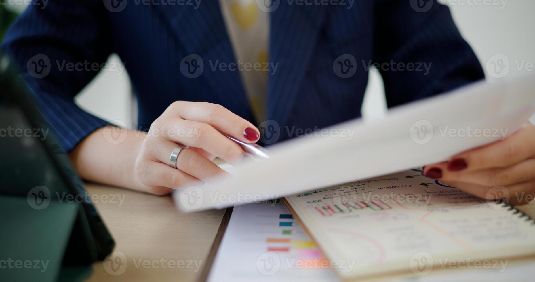 Selective focus, Hands of Asian businesswoman in suit use digital tablet for work and analyze documents in small coffee shop. Work from anywhere, Remote working photo