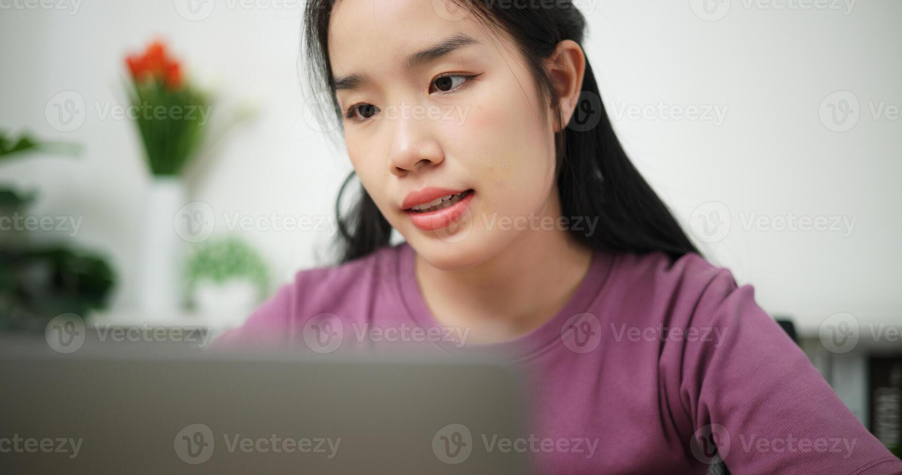 Selective focus, Young asian businesswoman using laptop for conference call presenting project plan to colleagues at home office, online meeting for remote work photo