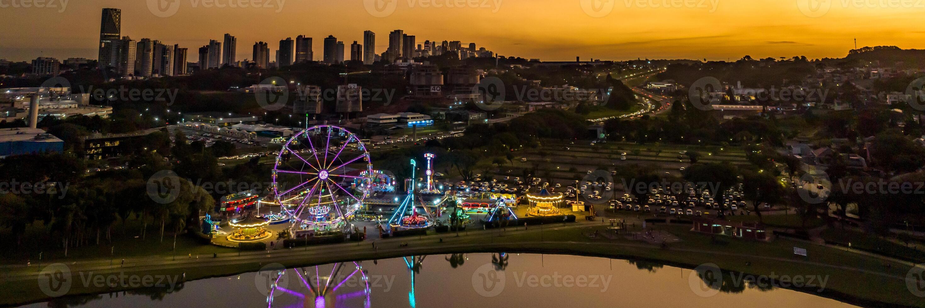 Curitiba in Parana, Brazil. Aerial View. Wonderful sunset with views of buildings and Tangua Park. Lake with reflection. photo