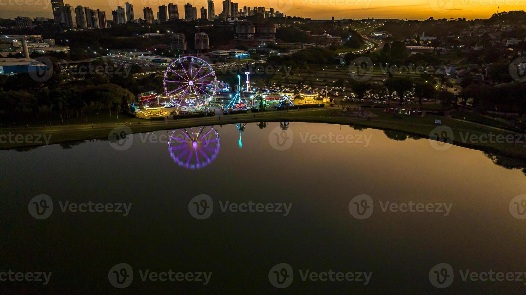 Curitiba in Parana, Brazil. Aerial View. Wonderful sunset with views of buildings and Tangua Park. Lake with reflection. photo