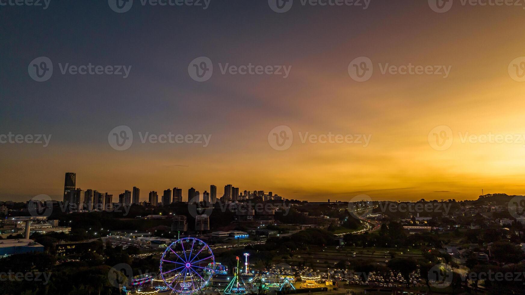 Curitiba in Parana, Brazil. Aerial View. Wonderful sunset with views of buildings and Tangua Park. Lake with reflection. photo