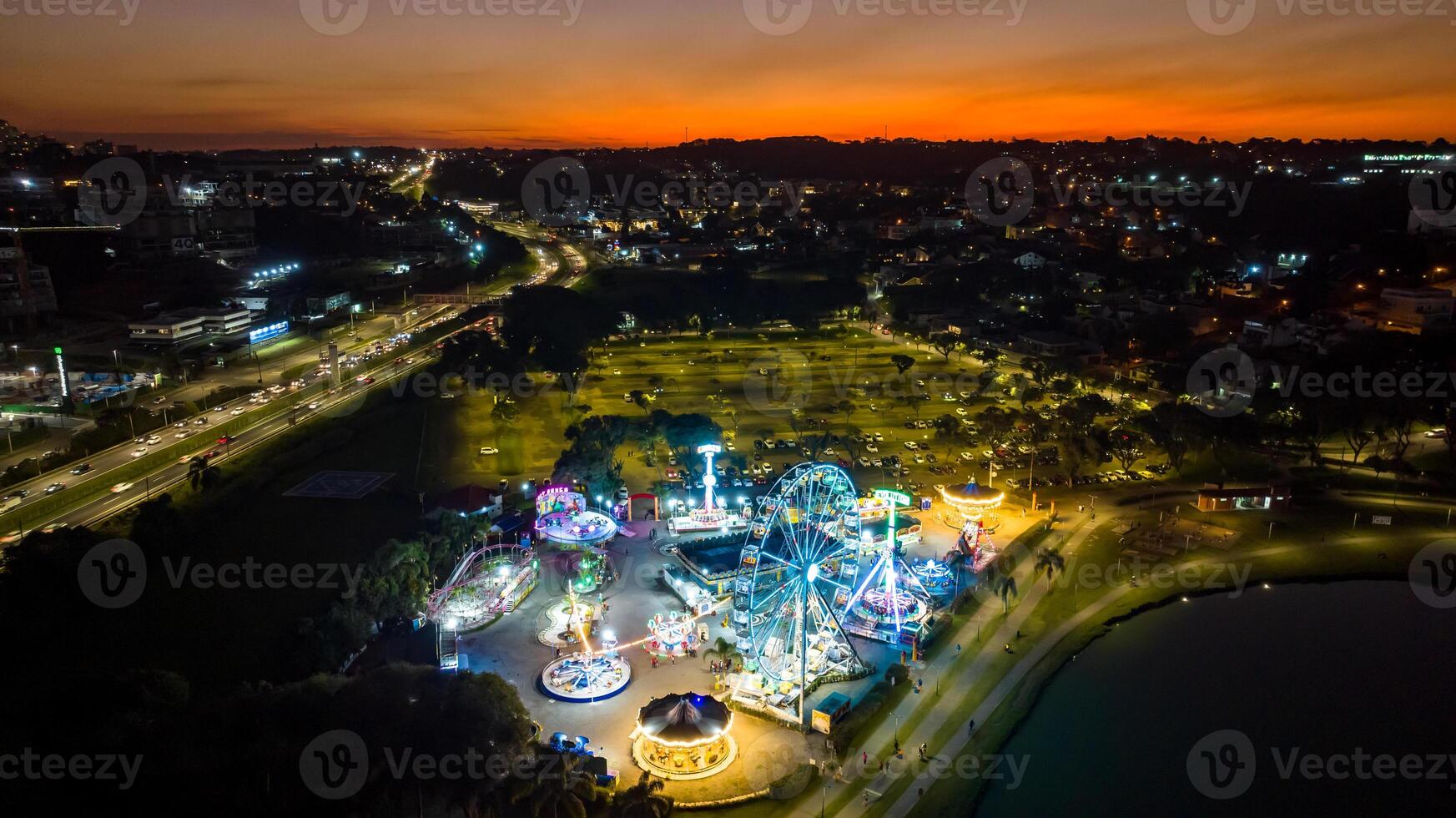 Curitiba in Parana, Brazil. Aerial View. Wonderful sunset with views of buildings and Tangua Park. Lake with reflection. photo