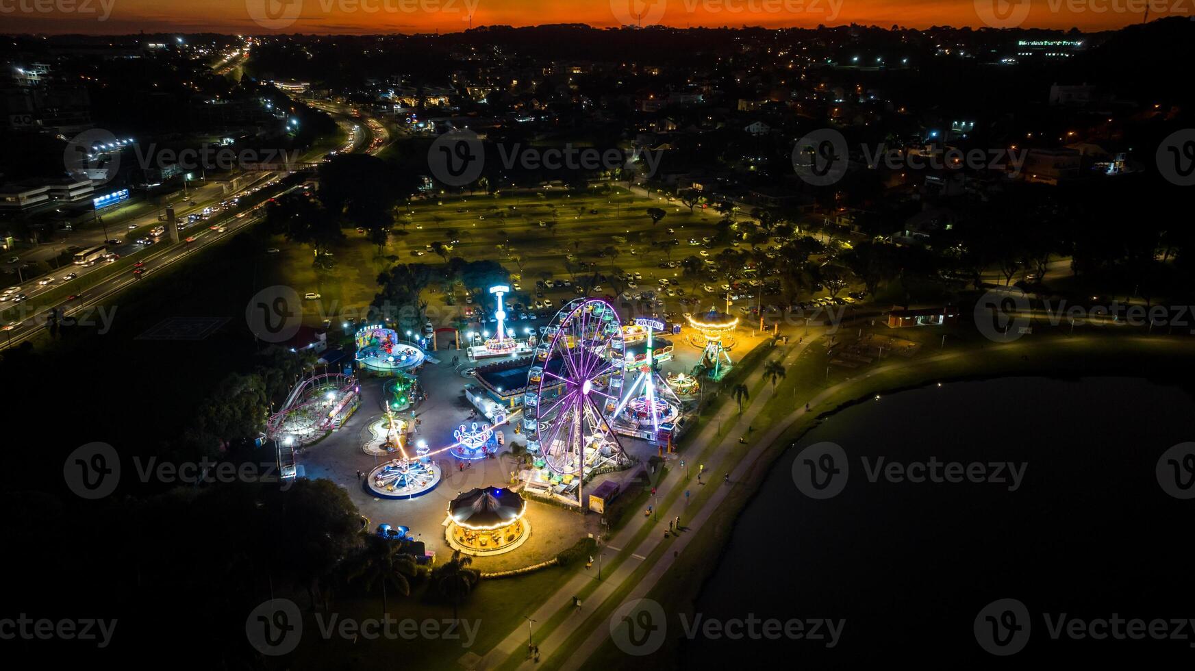 Curitiba in Parana, Brazil. Aerial View. Wonderful sunset with views of buildings and Tangua Park. Lake with reflection. photo
