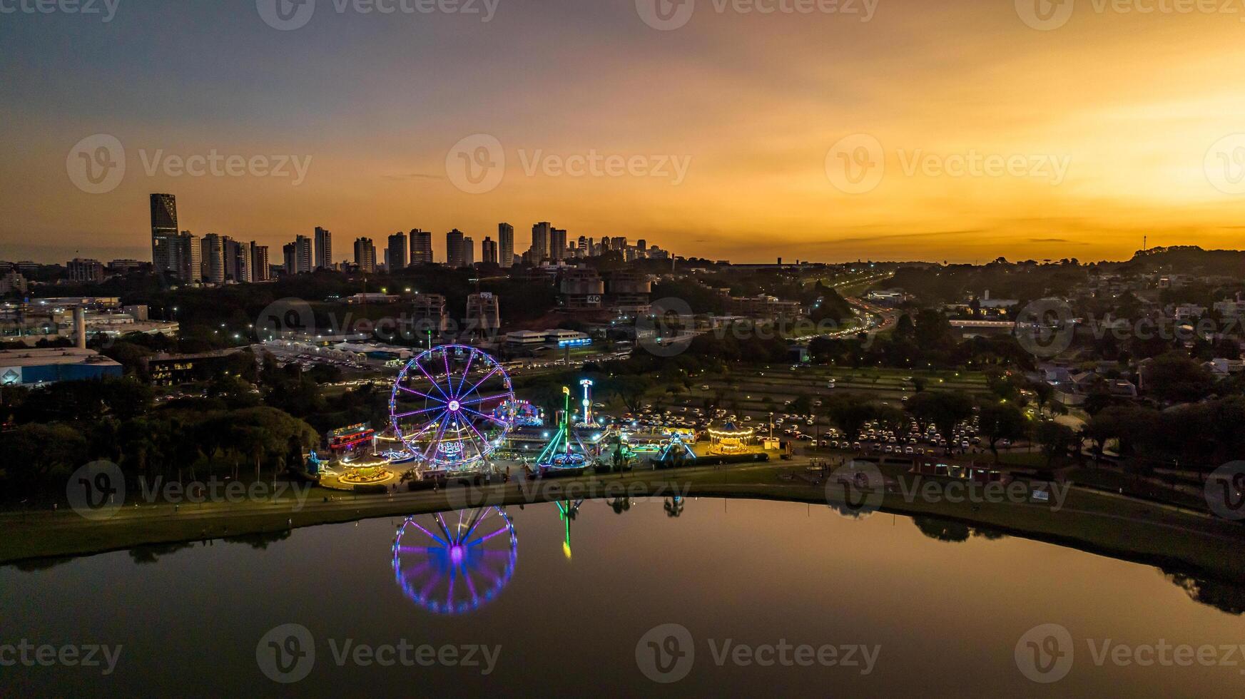 Curitiba in Parana, Brazil. Aerial View. Wonderful sunset with views of buildings and Tangua Park. Lake with reflection. photo