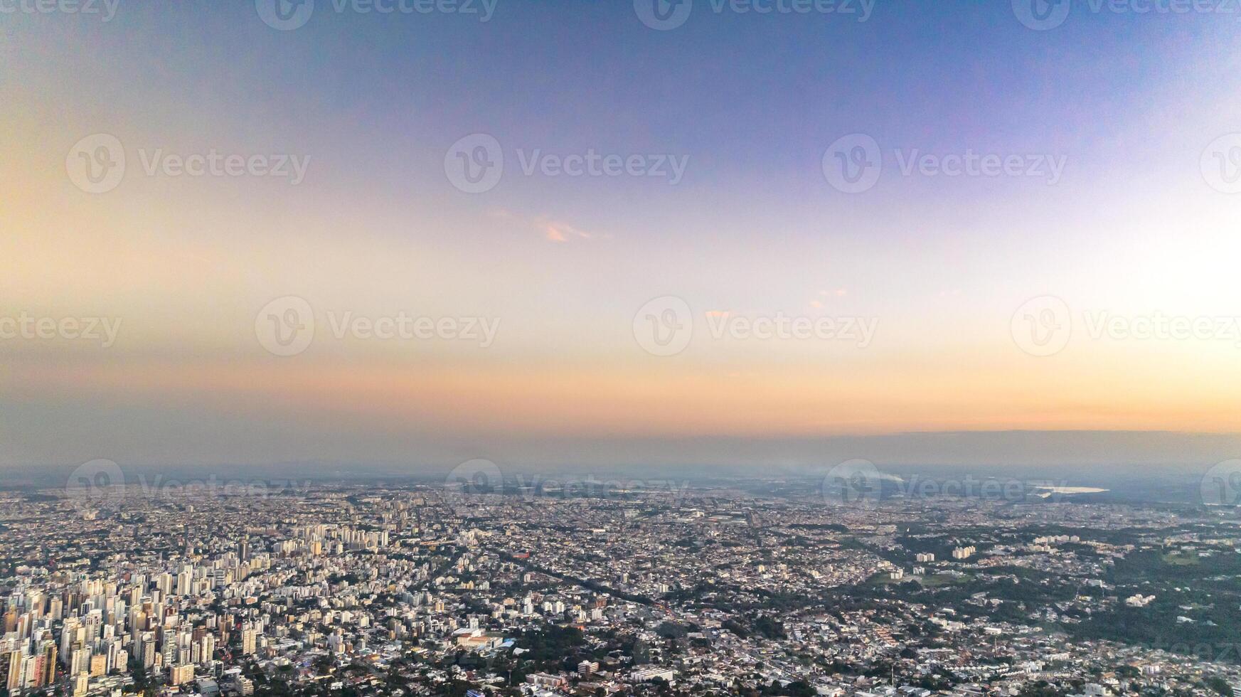 Curitiba in Parana, Brazil. Aerial View. Wonderful sunset with views of buildings and Tangua Park. Lake with reflection. photo
