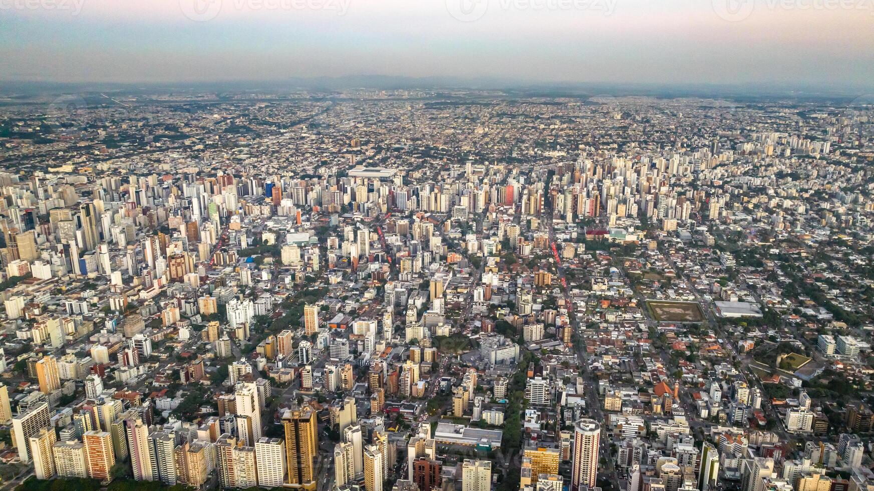 Curitiba in Parana, Brazil. Aerial View. Wonderful sunset with views of buildings and Tangua Park. Lake with reflection. photo