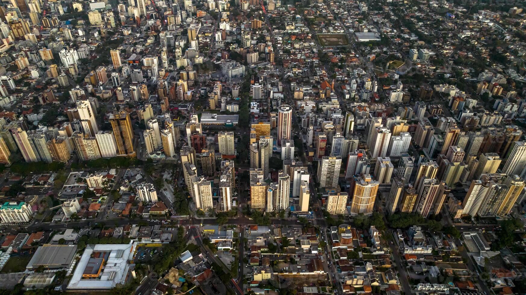 Curitiba in Parana, Brazil. Aerial View. Wonderful sunset with views of buildings and Tangua Park. Lake with reflection. photo
