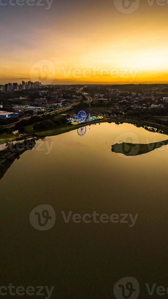 Curitiba in Parana, Brazil. Aerial View. Wonderful sunset with views of buildings and Tangua Park. Lake with reflection. photo
