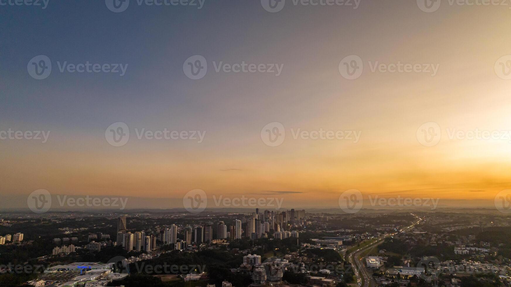 Curitiba in Parana, Brazil. Aerial View. Wonderful sunset with views of buildings and Tangua Park. Lake with reflection. photo