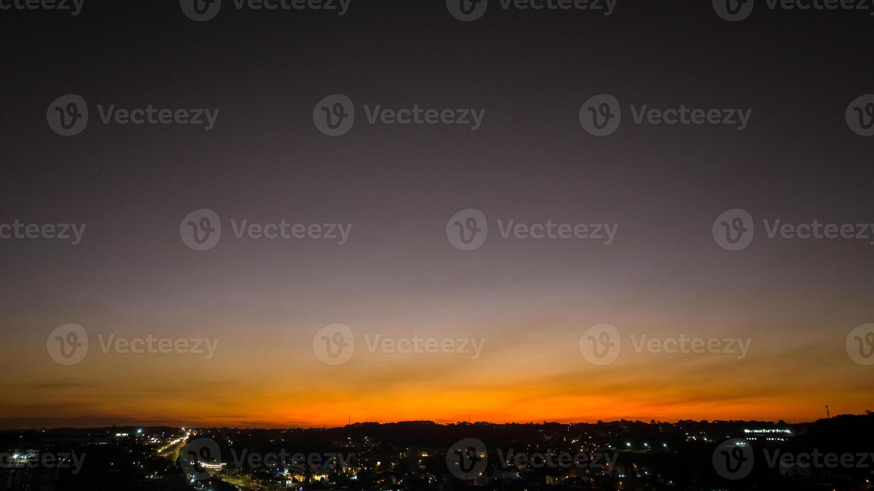 Curitiba in Parana, Brazil. Aerial View. Wonderful sunset with views of buildings and Tangua Park. Lake with reflection. photo