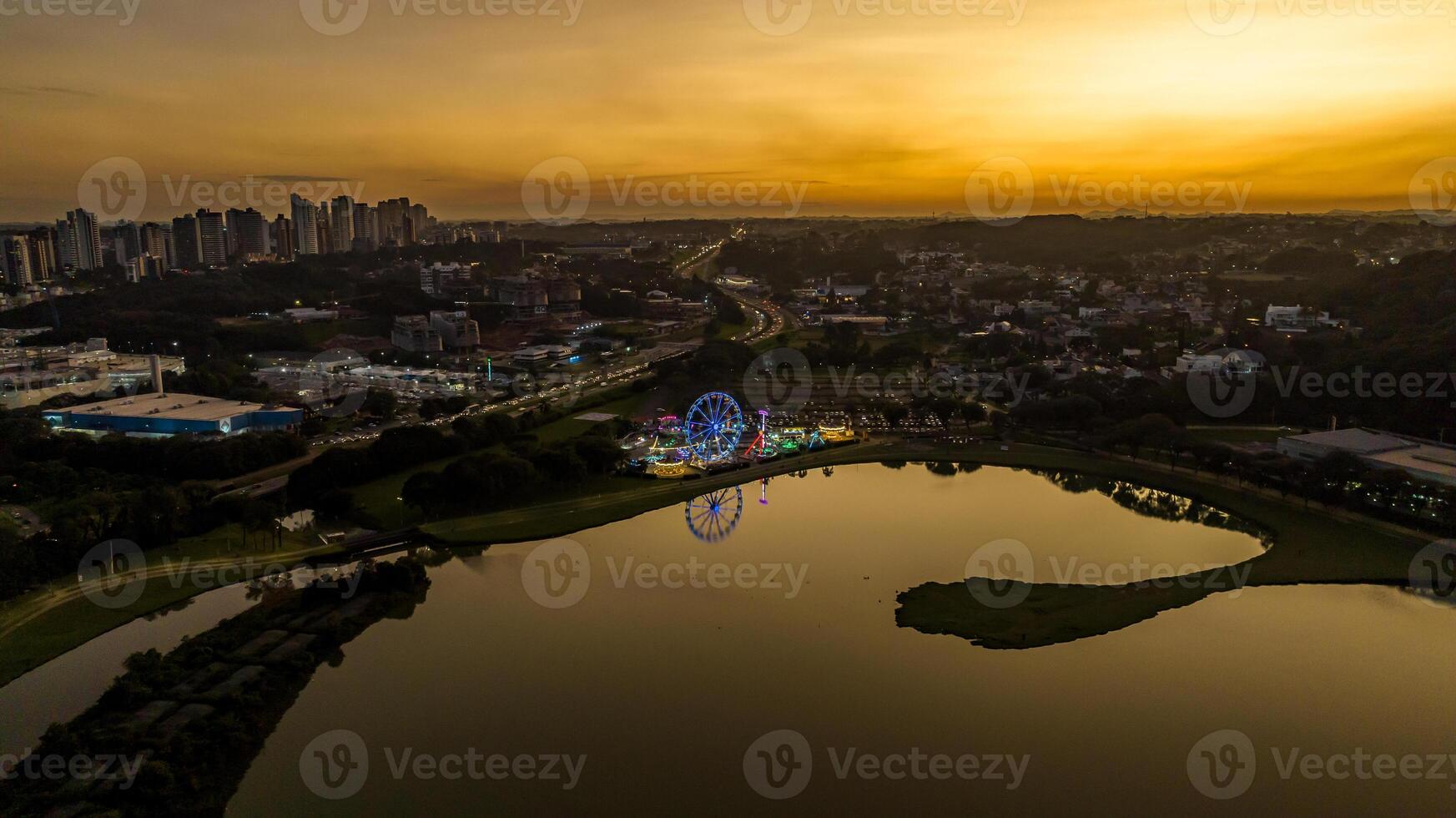 Curitiba in Parana, Brazil. Aerial View. Wonderful sunset with views of buildings and Tangua Park. Lake with reflection. photo