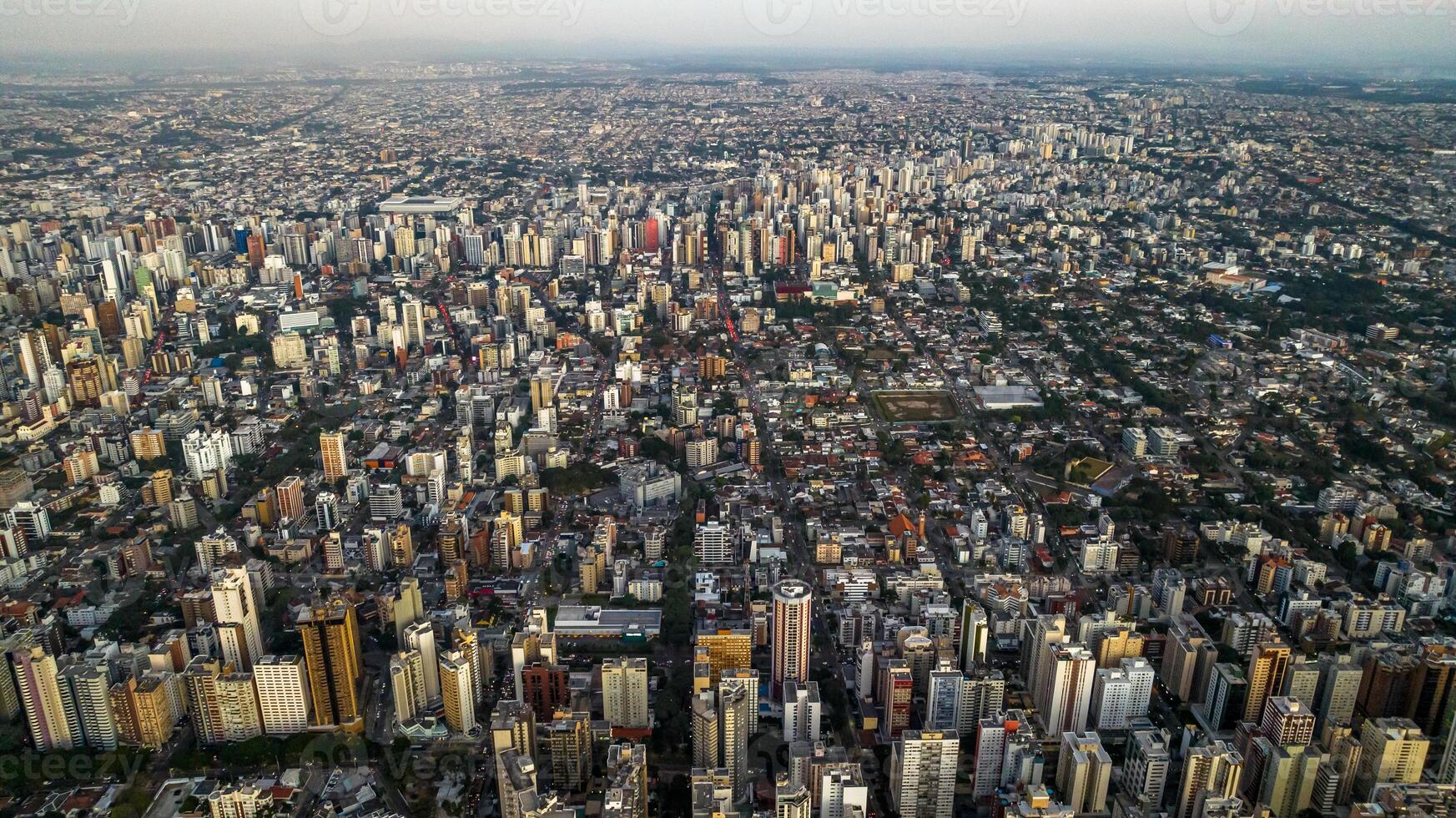 Curitiba in Parana, Brazil. Aerial View. Wonderful sunset with views of buildings and Tangua Park. Lake with reflection. photo