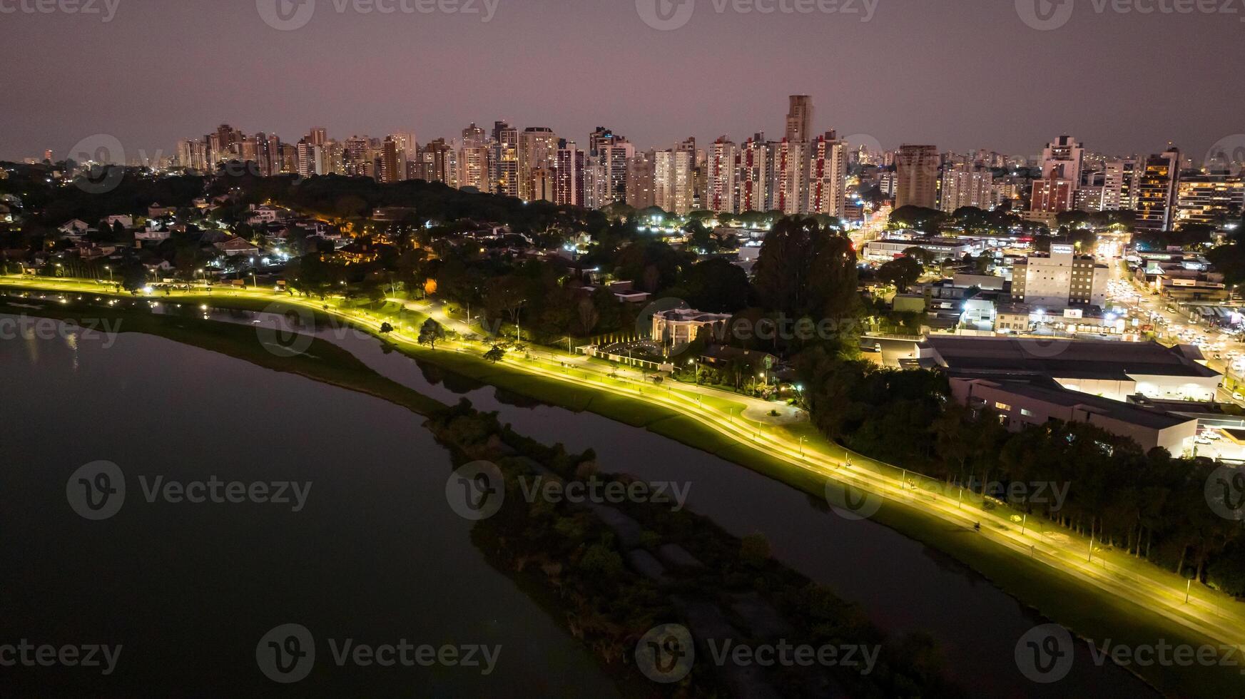 Curitiba in Parana, Brazil. Aerial View. Wonderful sunset with views of buildings and Tangua Park. Lake with reflection. photo