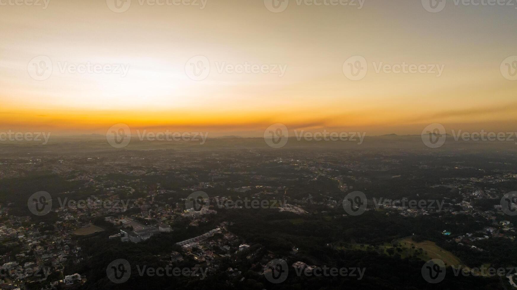 Curitiba in Parana, Brazil. Aerial View. Wonderful sunset with views of buildings and Tangua Park. Lake with reflection. photo