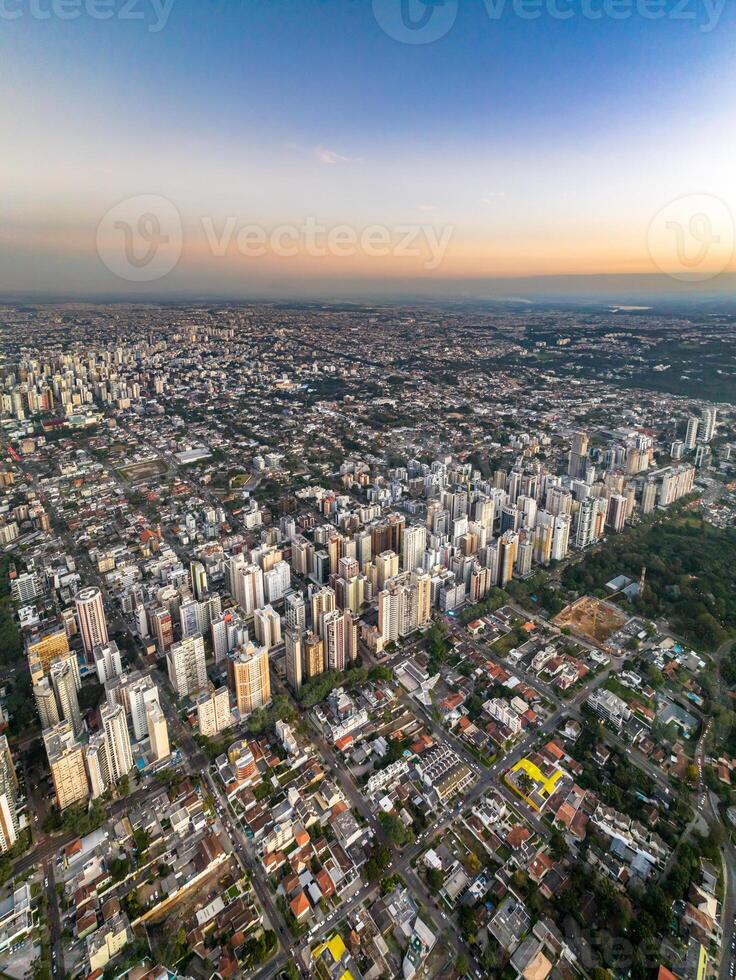 Curitiba in Parana, Brazil. Aerial View. Wonderful sunset with views of buildings and Tangua Park. Lake with reflection. photo