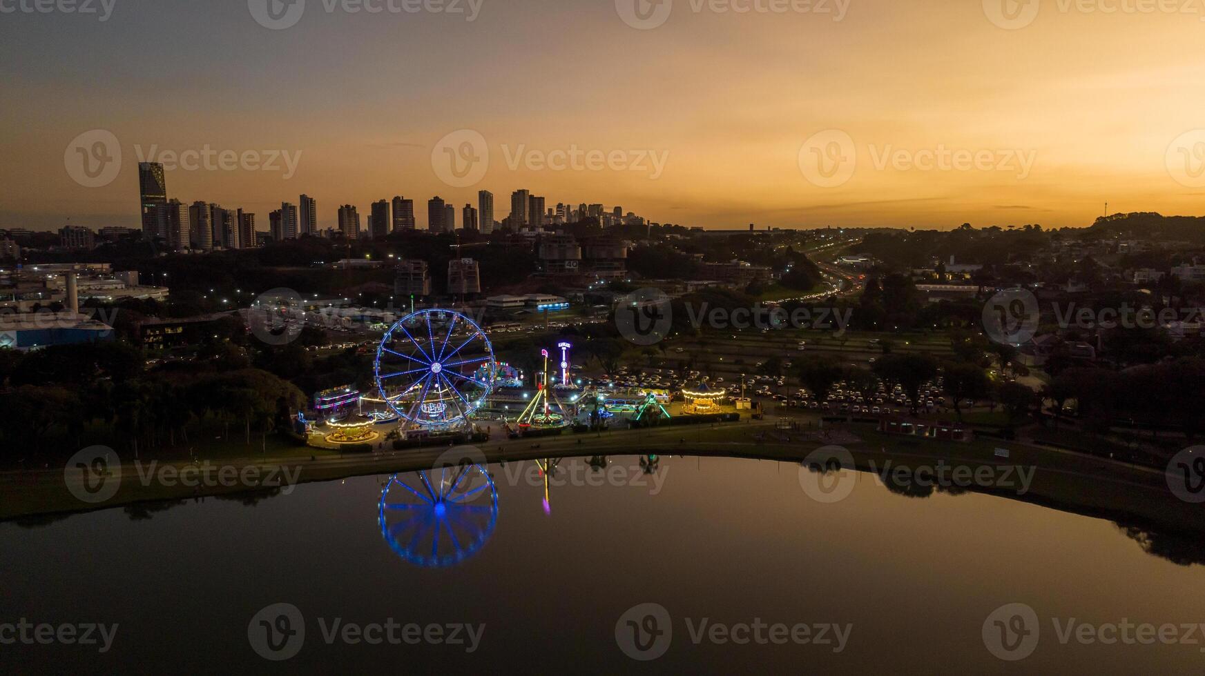 Curitiba in Parana, Brazil. Aerial View. Wonderful sunset with views of buildings and Tangua Park. Lake with reflection. photo